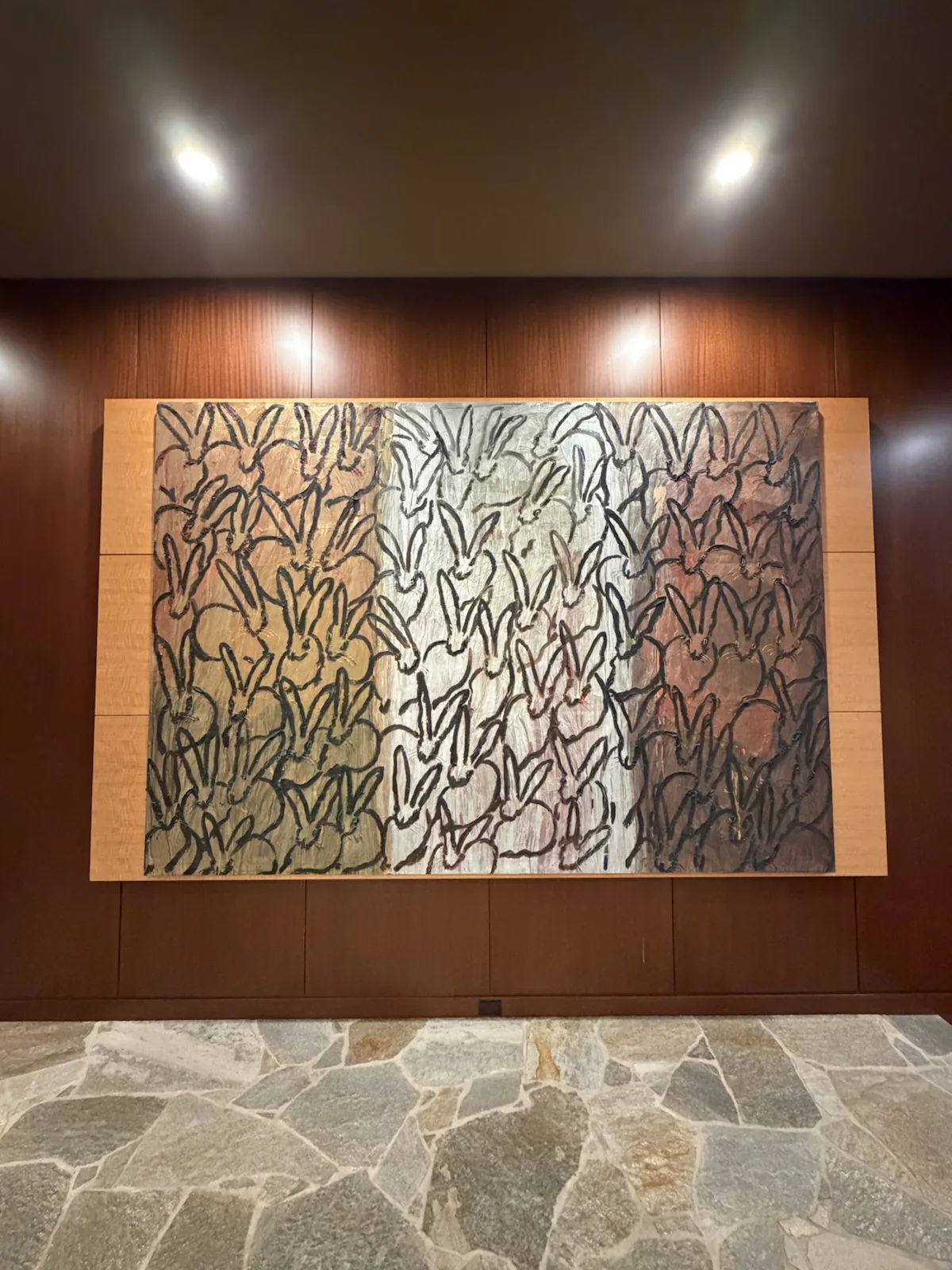 Oversized fine art installation in a finished Chicago home by ORLEG Mounting Services