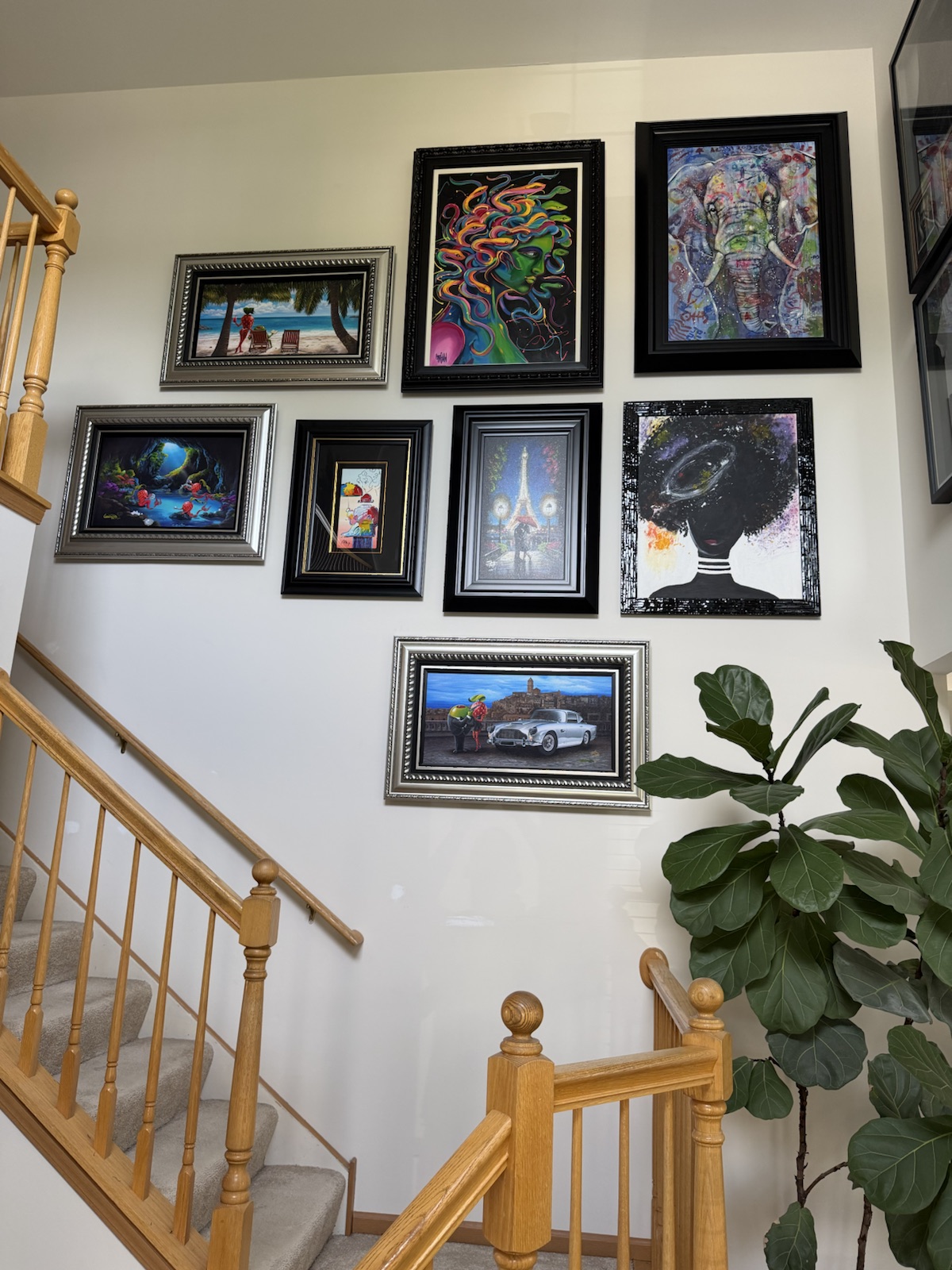 Gallery wall installation on a stairwell with careful alignment