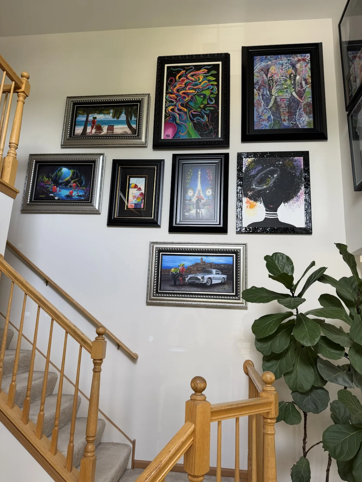 Gallery wall installation on a stairwell with careful alignment